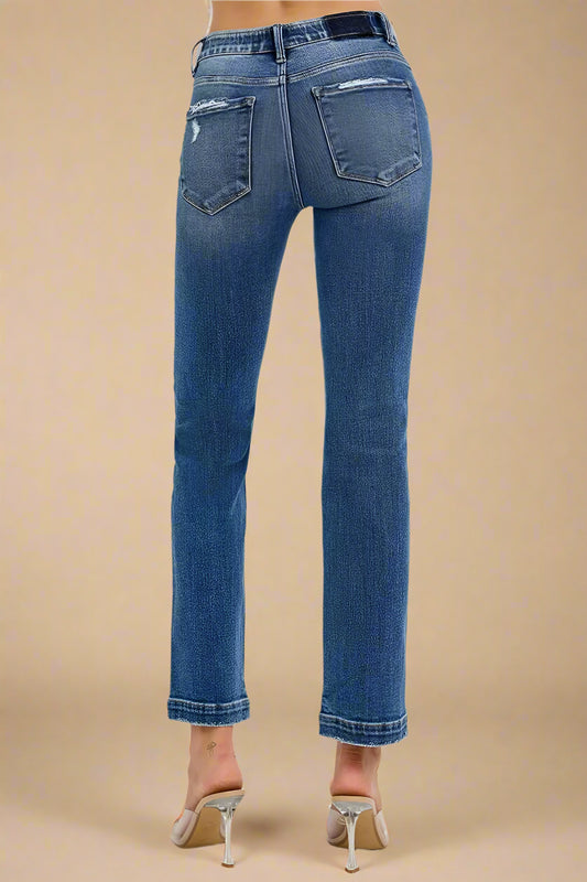 Blue jeans worn by a person on a white background