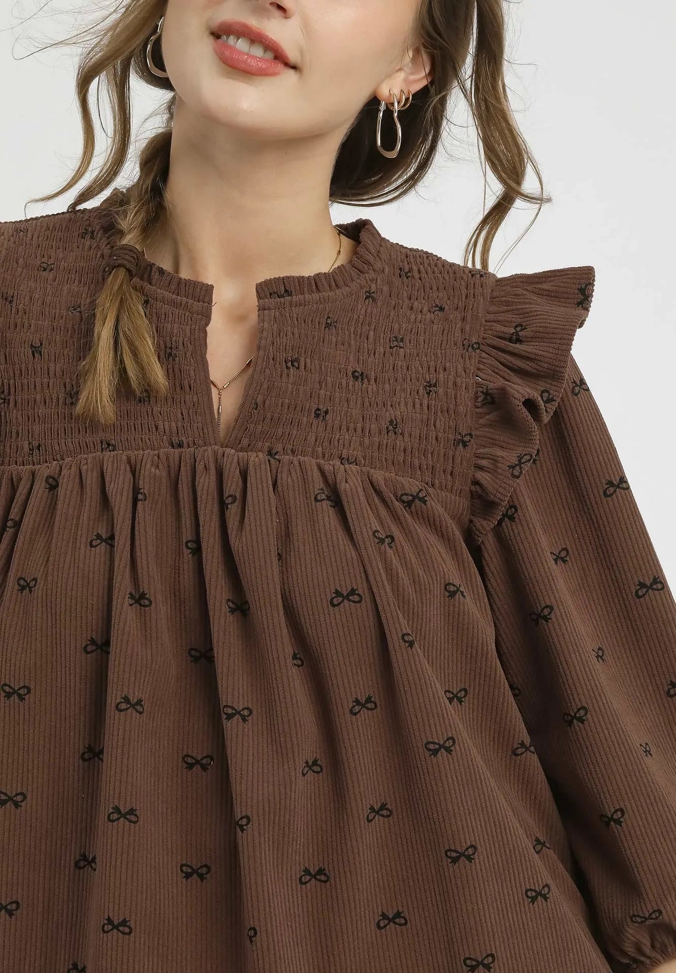 Brown dress with black patterns on a white background