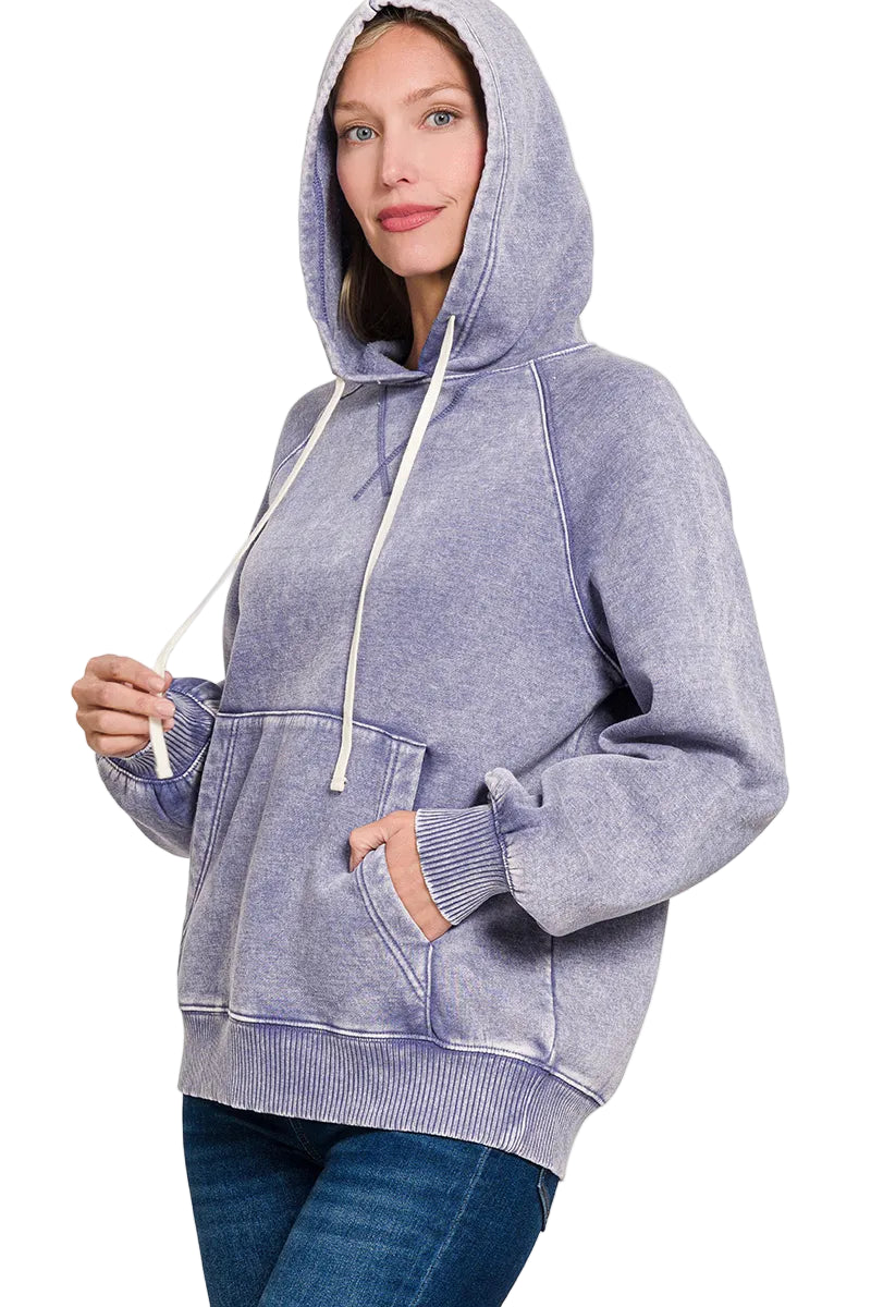 Woman wearing a marl blue hoodie on a white background