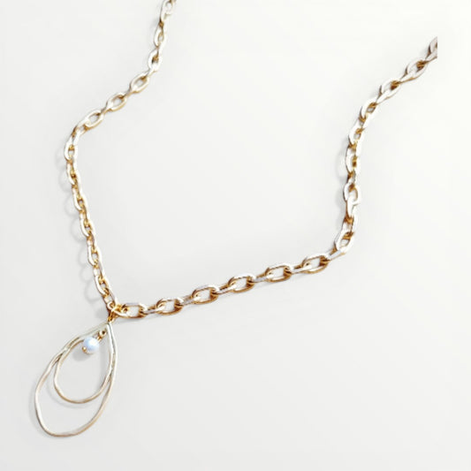 Gold necklace with a pendant on a white background