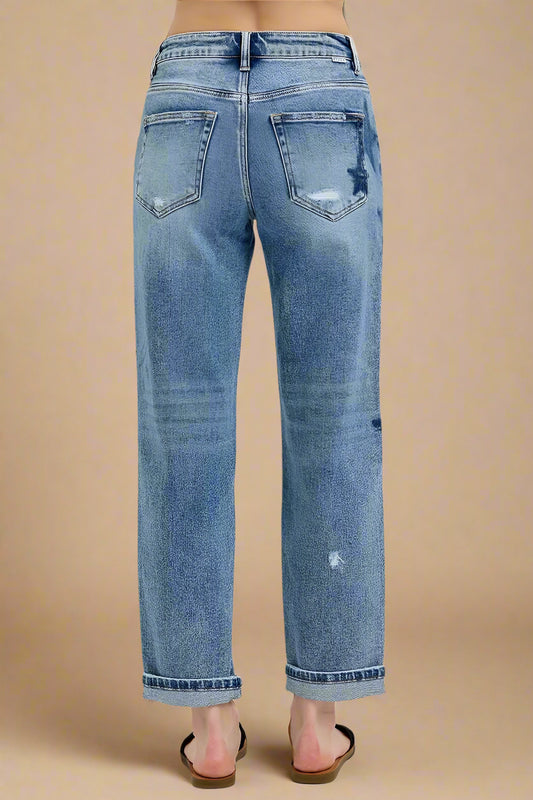 Blue jeans with a slight distressed look on a white background