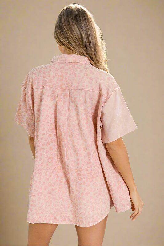 Woman wearing a pink floral shirt on a beige background
