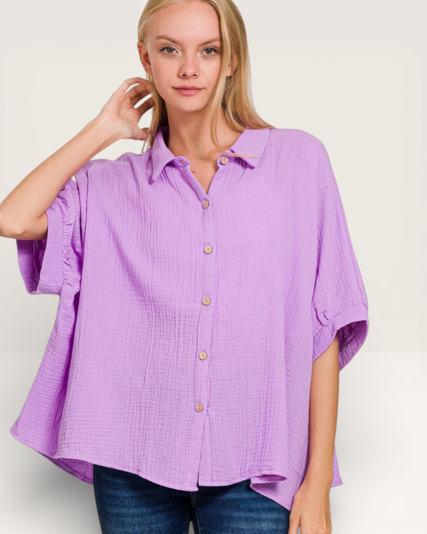 Woman wearing a purple button-up shirt on a white background