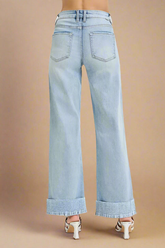 Light blue wide-leg jeans on a beige background