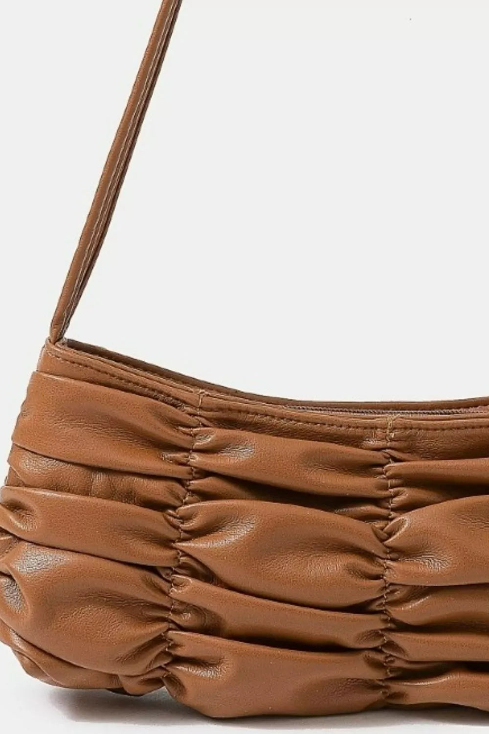 Brown leather handbag with a strap on a white background