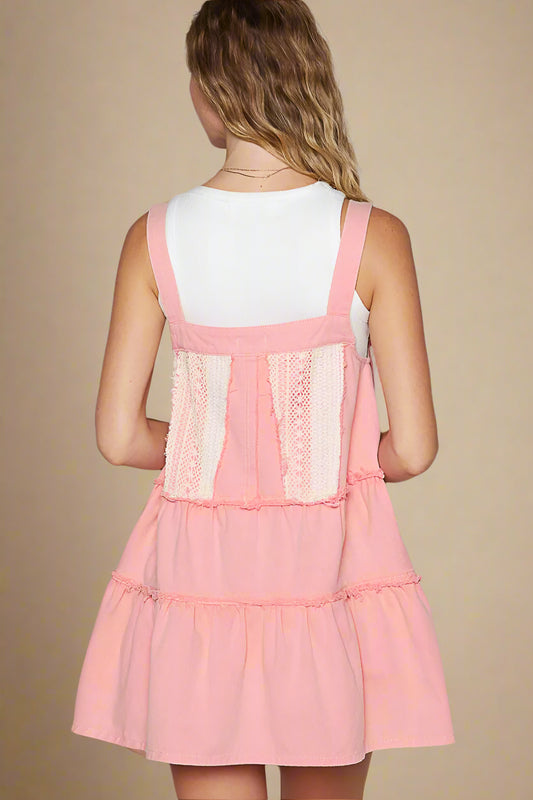 Pink dress with lace details on a plain background