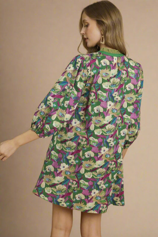 Woman wearing a floral dress with green background
