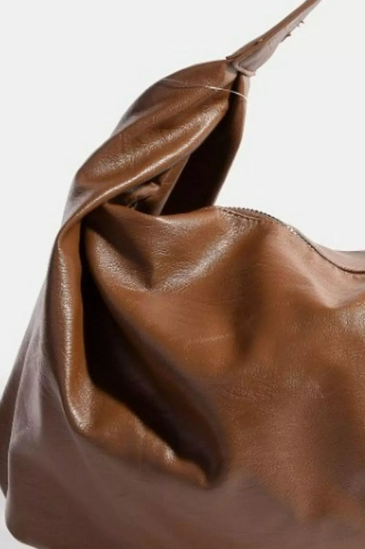 Brown leather handbag on a white background