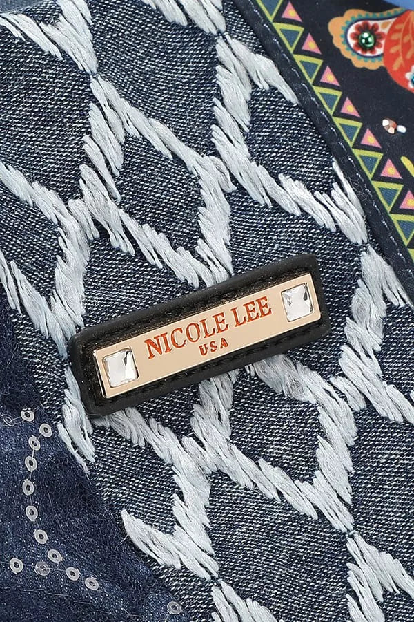 Close-up of a denim fabric with a 'Nicole Lee' label on a patterned background