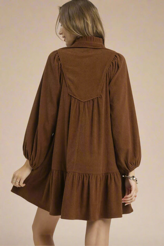 Brown dress worn by a person on a white background