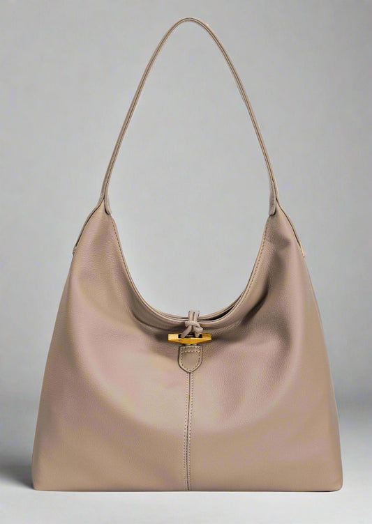 Beige handbag with a gold clasp on a white background