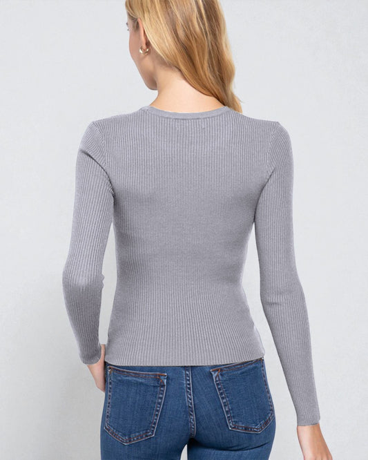 Person wearing a gray ribbed long-sleeve top and blue jeans on a light gray background