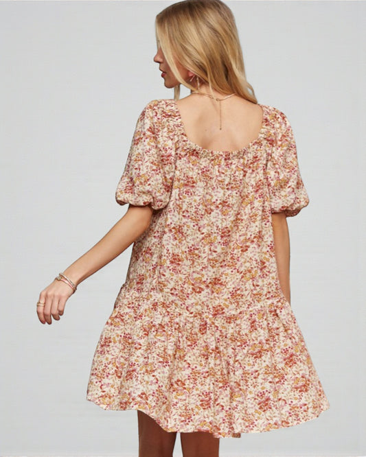 Woman wearing a floral dress on a plain background