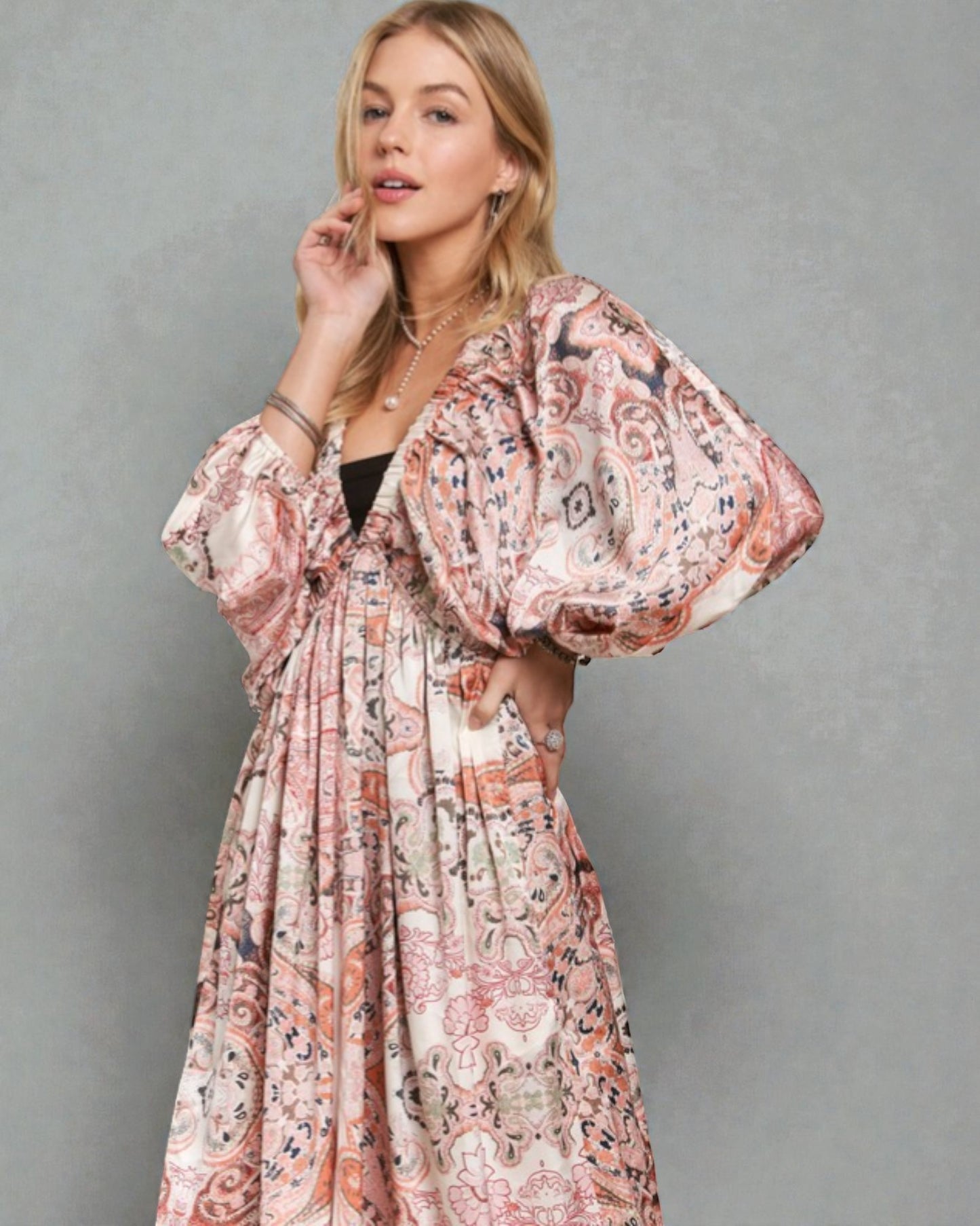 Woman wearing a floral dress against a gray background