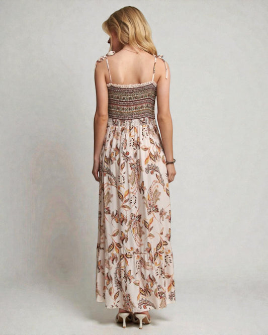 Woman wearing a floral dress with a plain background