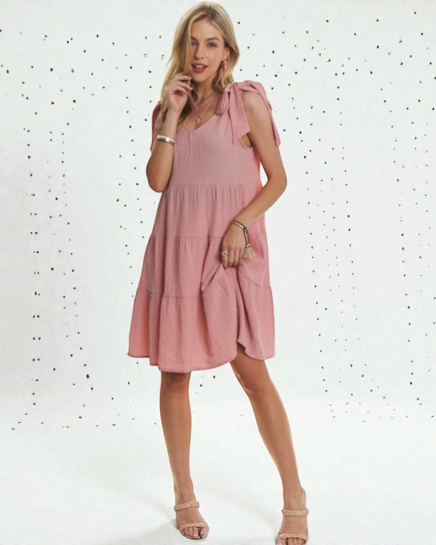 Woman wearing a pink dress against a white background