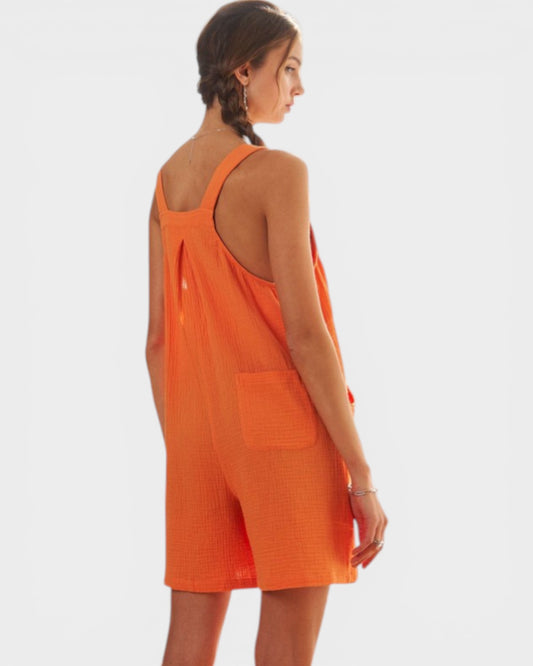 Woman wearing an orange dress on a white background