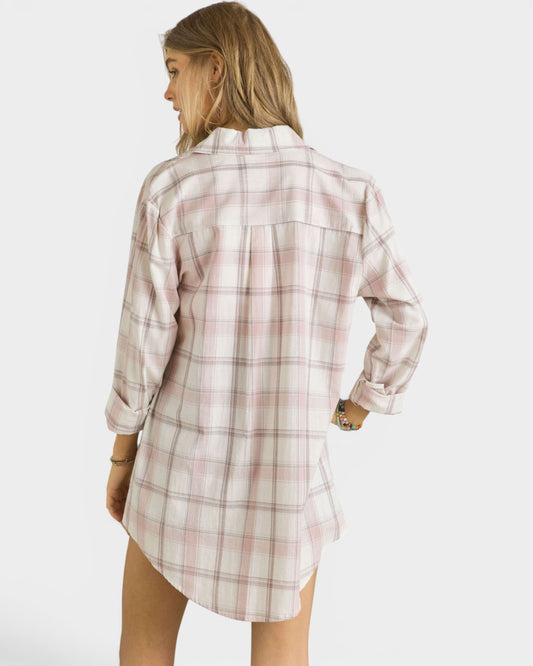 Woman wearing a plaid shirt dress on a white background