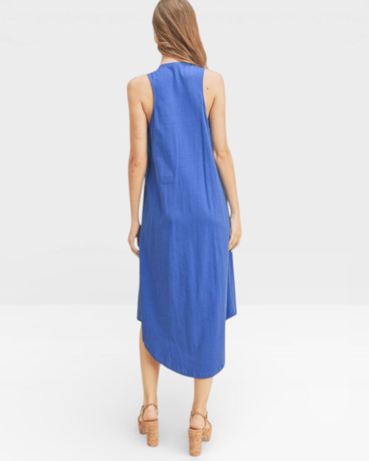 Woman wearing a blue sleeveless dress on a white background