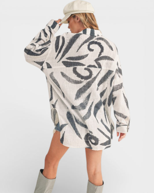 Person wearing a patterned sweater with a plain background