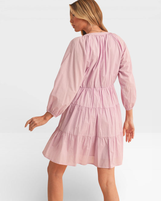 Woman wearing a pink dress on a white background