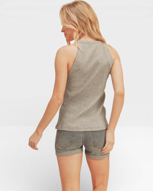 Woman wearing a sleeveless top and shorts on a white background