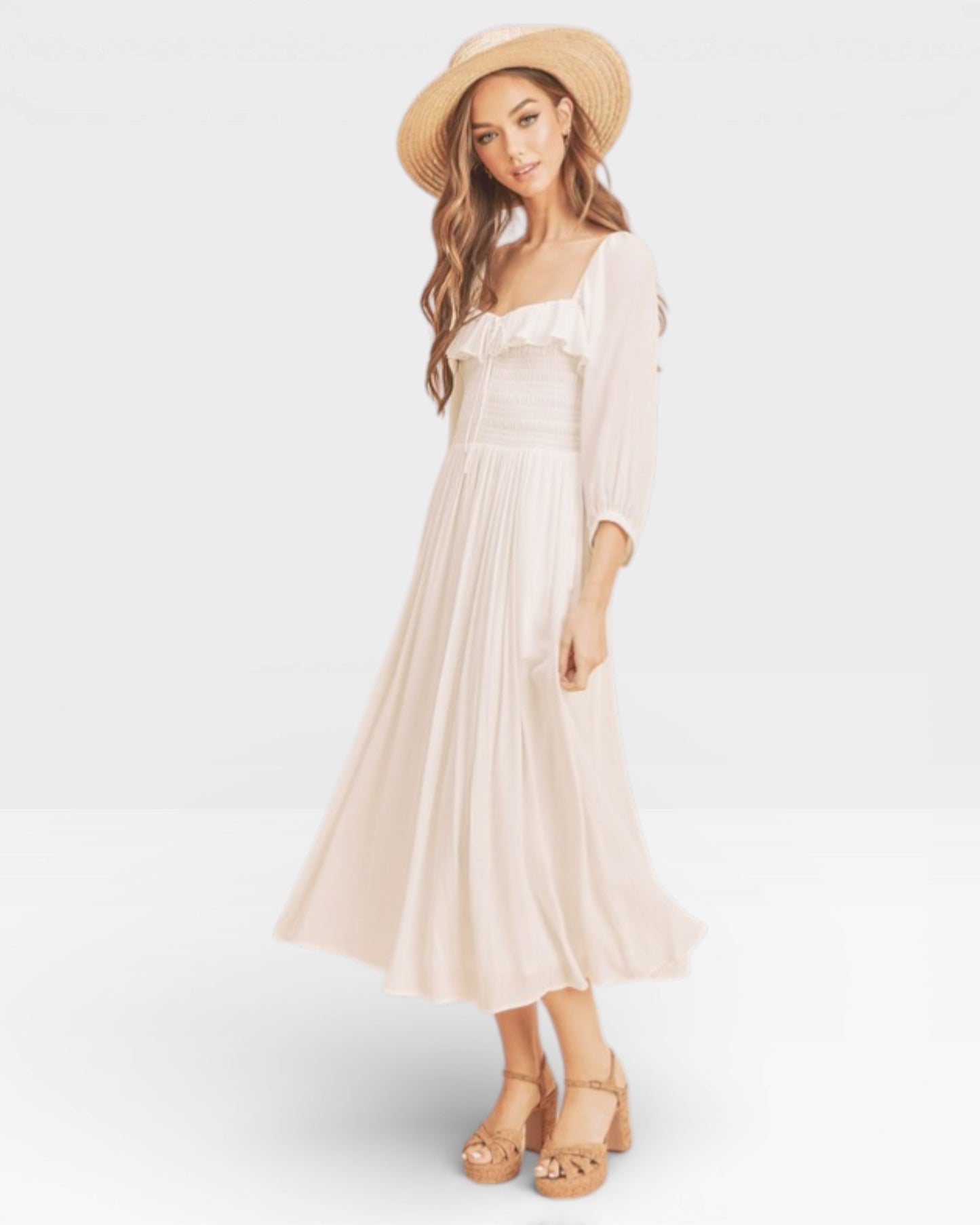 Woman wearing a white dress and straw hat on a light gray background