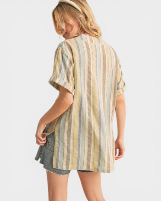 Woman wearing a striped shirt and denim shorts on a white background