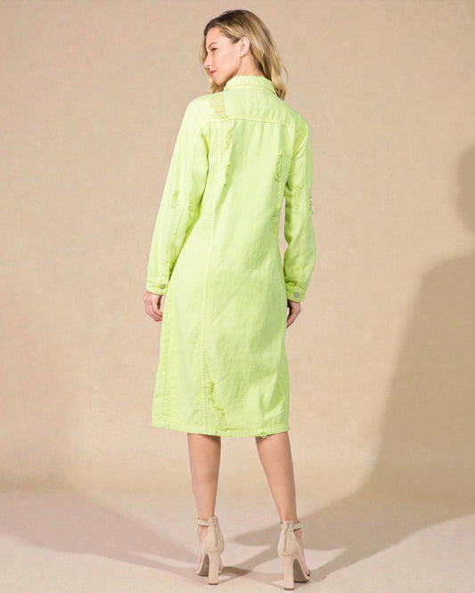 Woman wearing a bright green dress against a beige background
