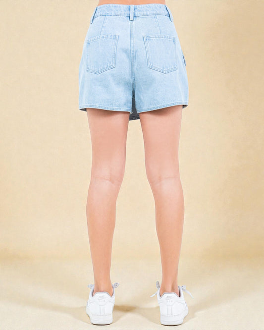 Light blue denim shorts worn by a person on a beige background