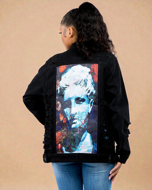 Person wearing a black jacket with a colorful graphic on the back against a beige background