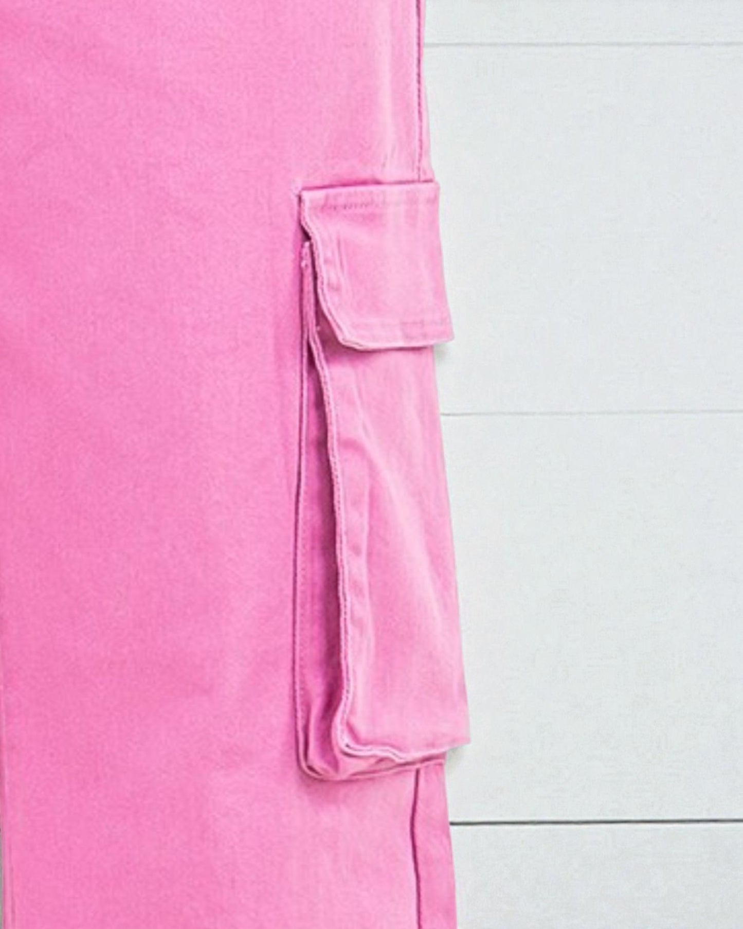 Close-up of a pink garment with a pocket on a white background