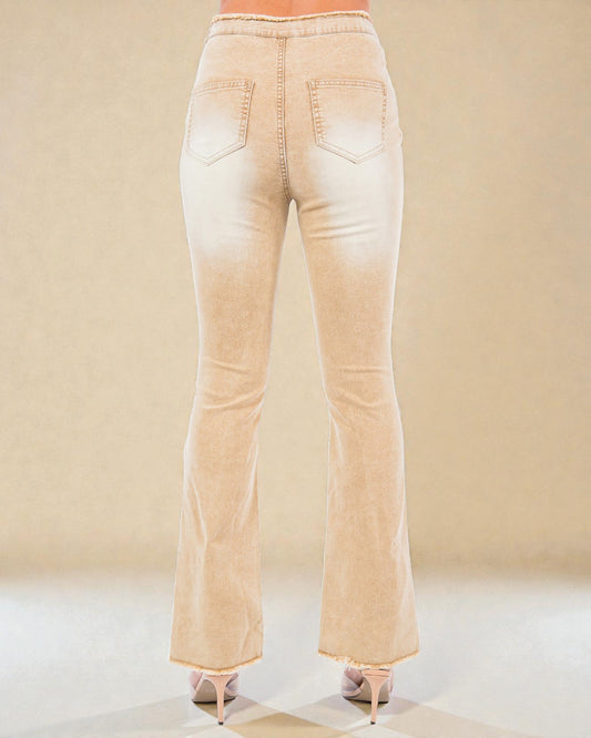 Beige flared jeans on a neutral background
