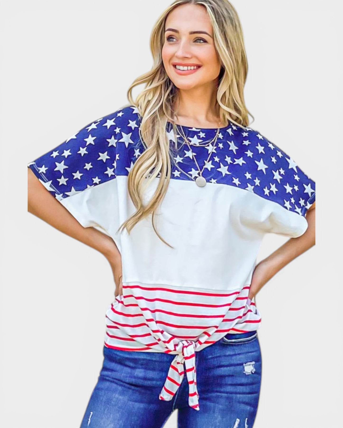 Woman wearing a shirt with American flag design on a plain background