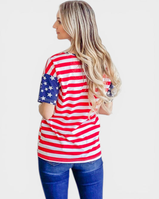 Woman wearing a red, white, and blue striped shirt with American flag sleeves on a white background