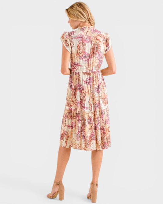 Woman wearing a patterned dress on a white background