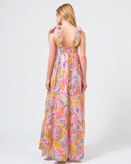 Woman wearing a colorful paisley dress on a white background