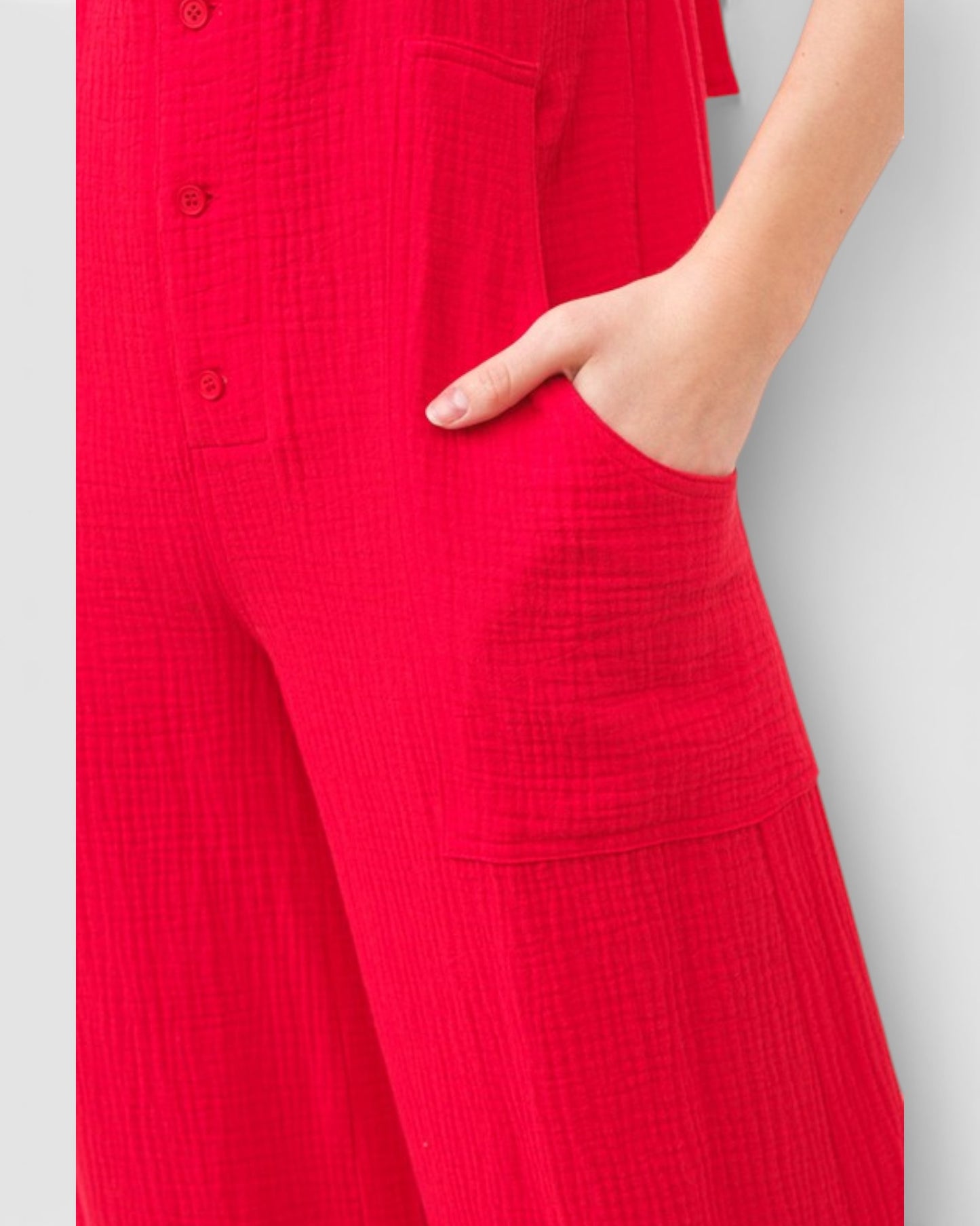 Red textured dress with a pocket on a light gray background