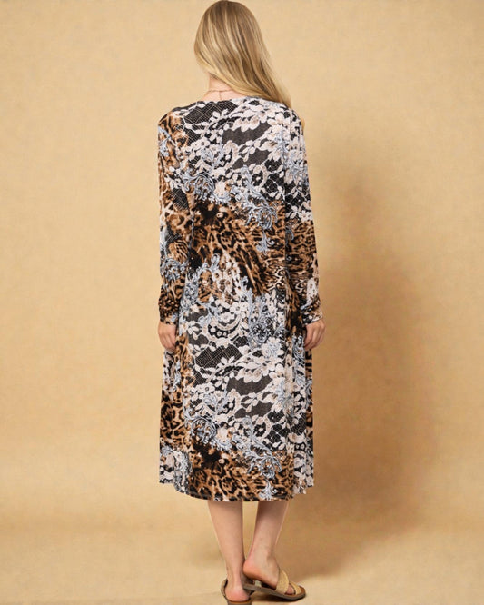 Woman wearing a long-sleeve dress with a floral and leopard print pattern on a beige background