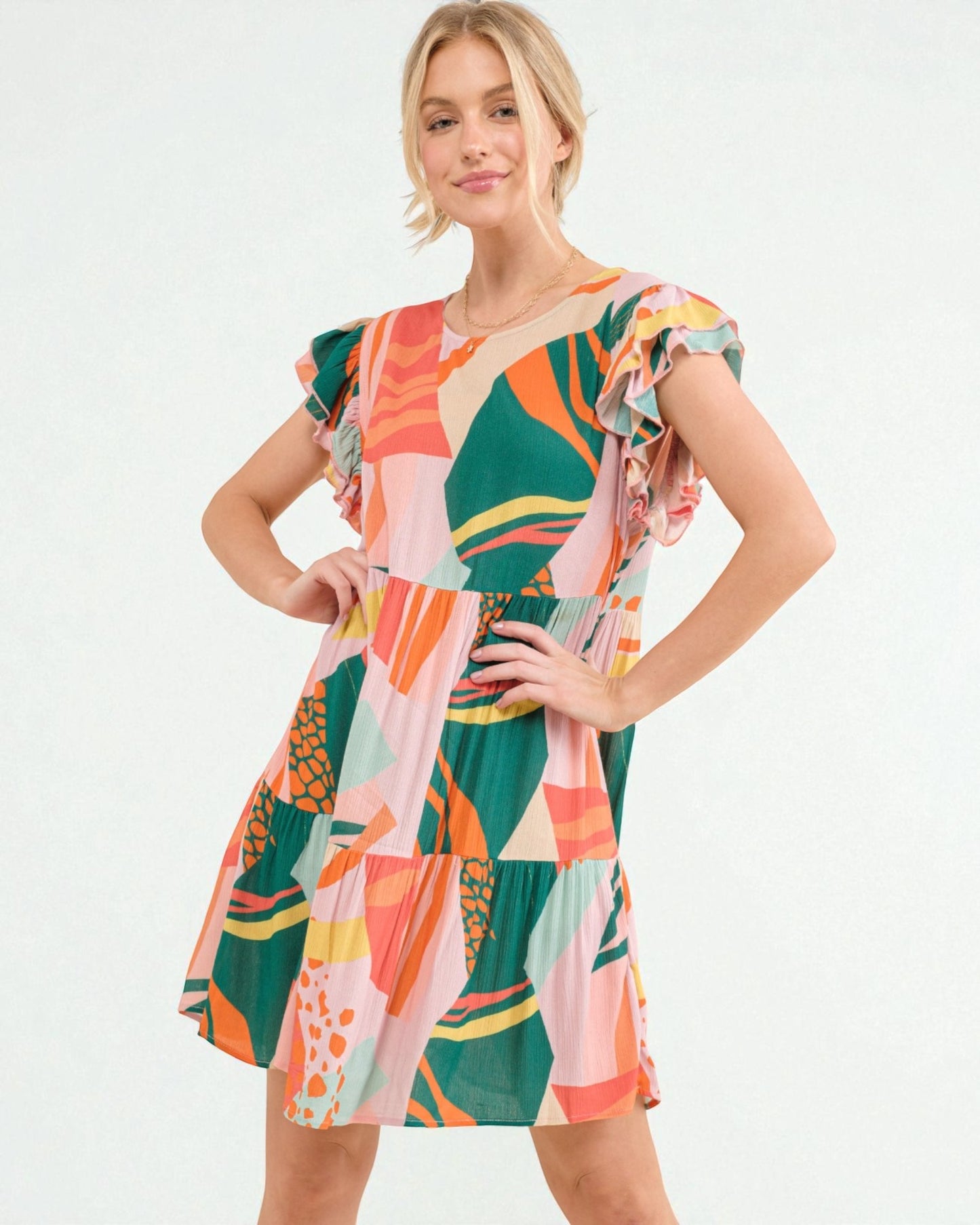 Woman wearing a colorful patterned dress on a white background