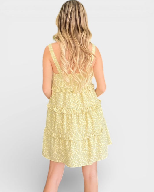 Woman wearing a yellow floral dress on a white background