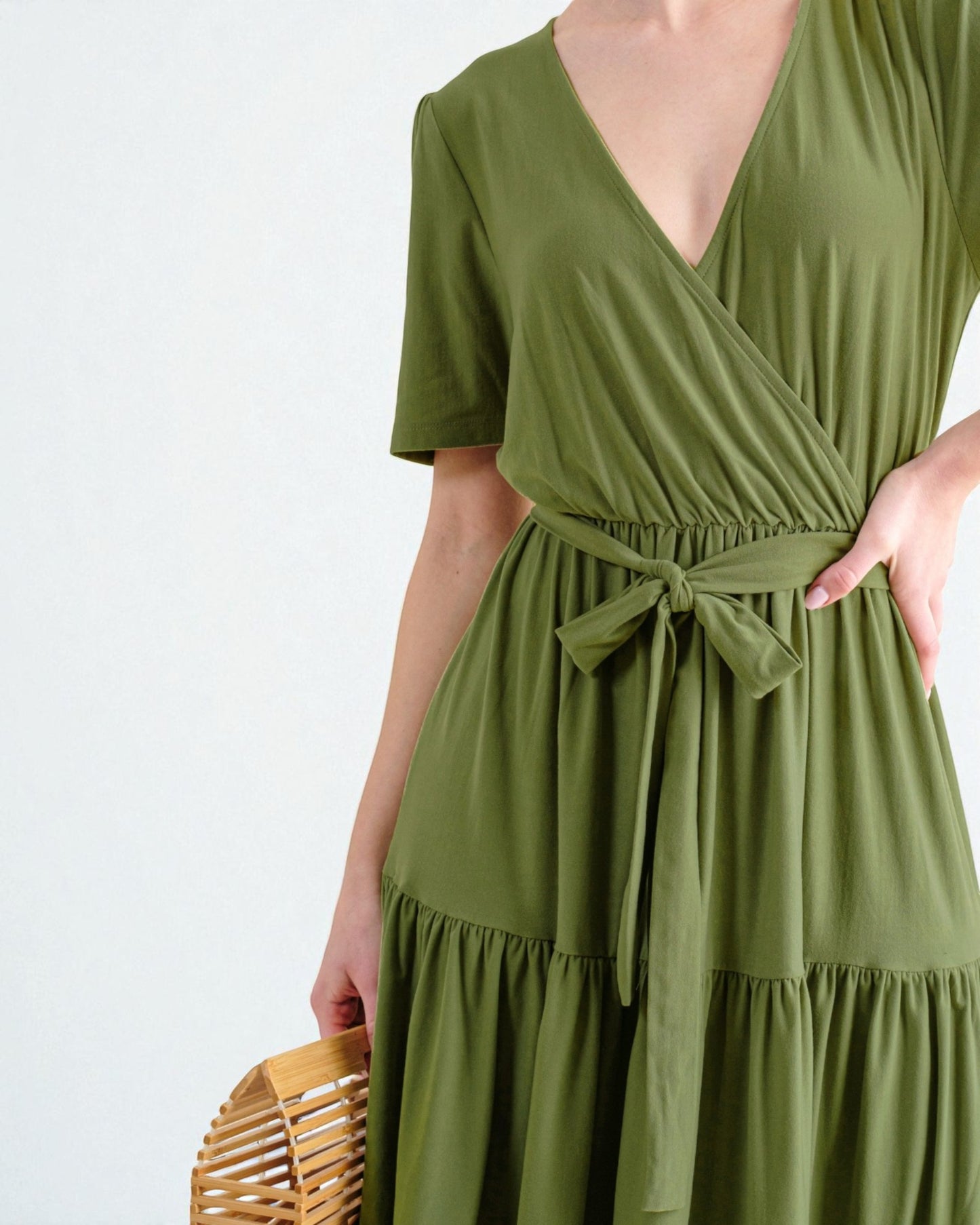 Green dress worn by a person on a white background