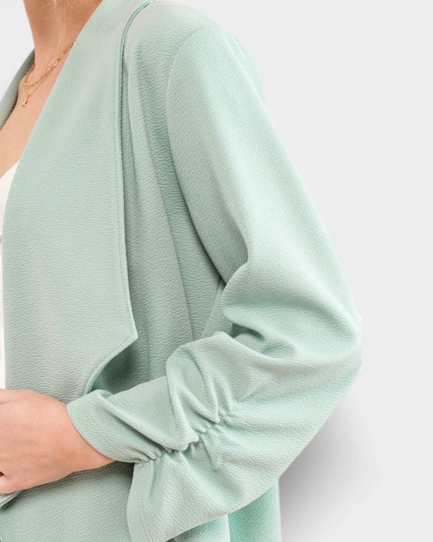 Light green sweater with long sleeves on a white background