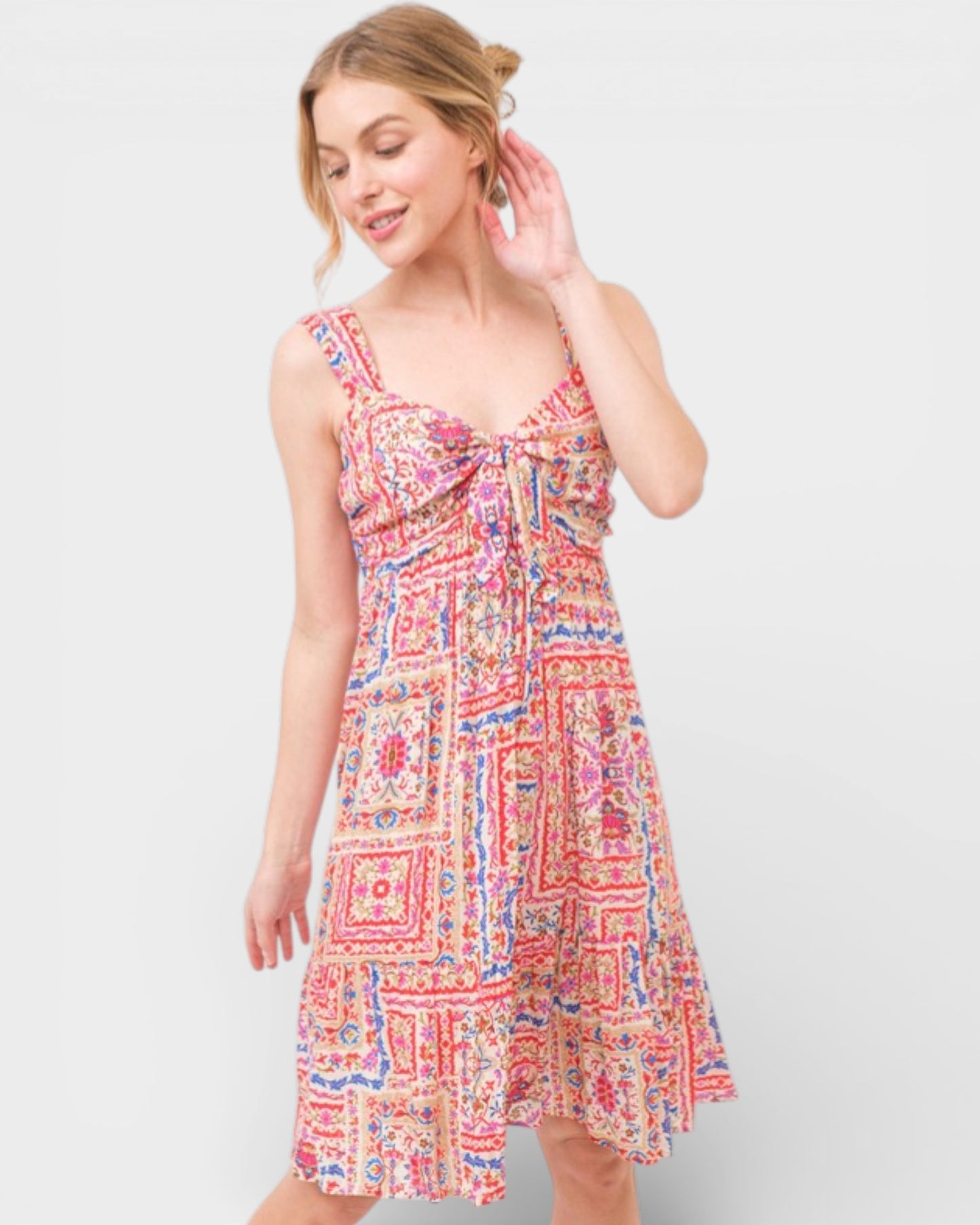 Woman wearing a colorful patterned dress on a white background