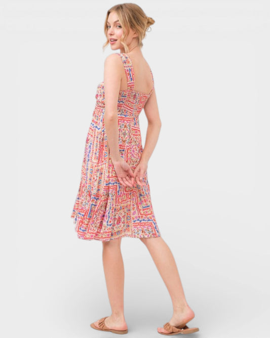 Woman wearing a patterned dress on a white background