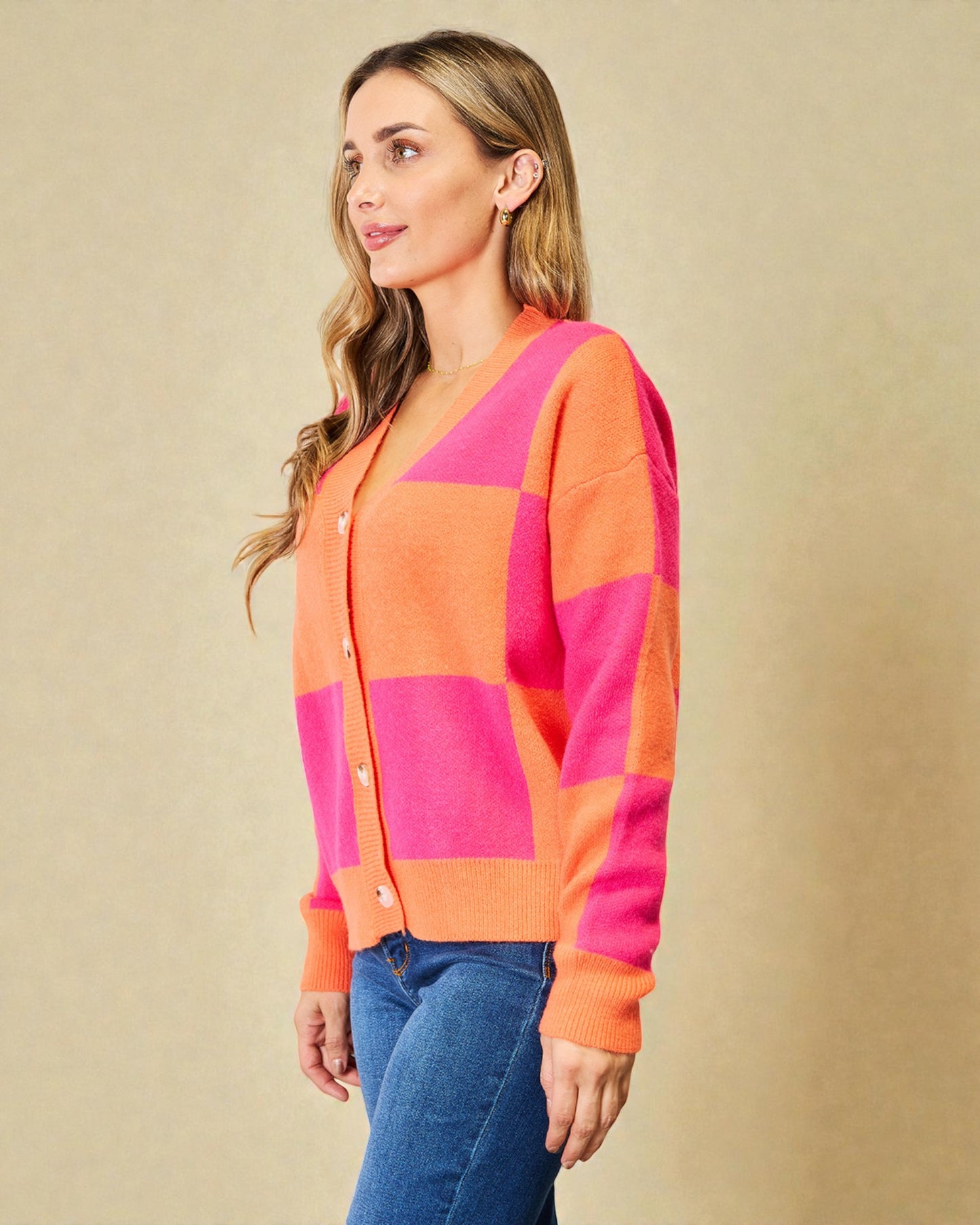 Woman wearing a colorful cardigan with a beige background