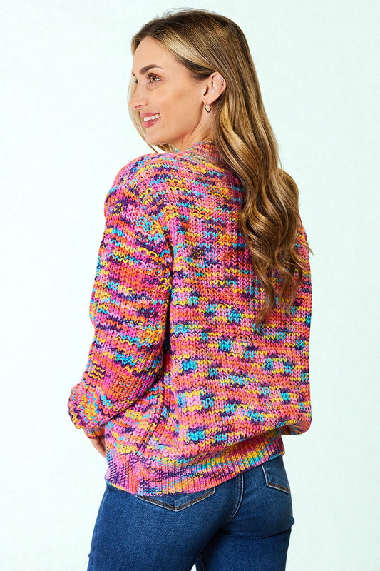 Woman wearing a colorful patterned sweater against a white background