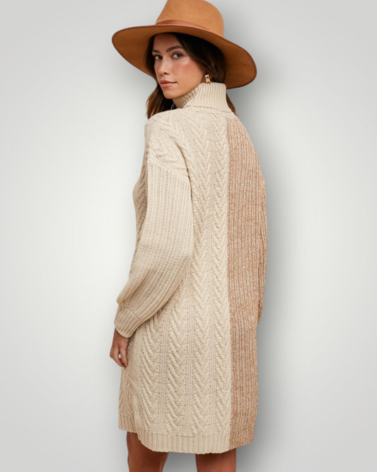 Woman wearing a beige cable knit sweater and brown hat against a white background