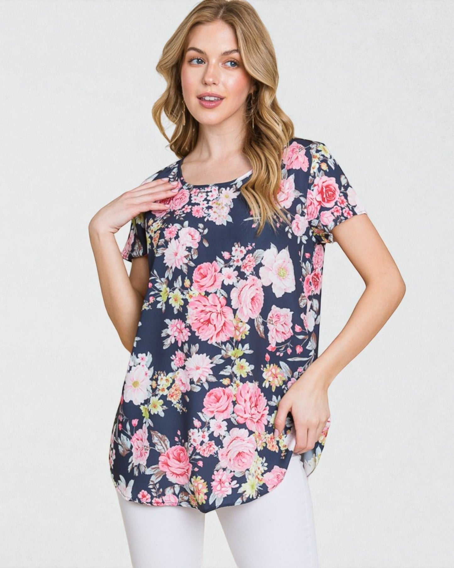 Woman wearing a floral print t-shirt on a plain background
