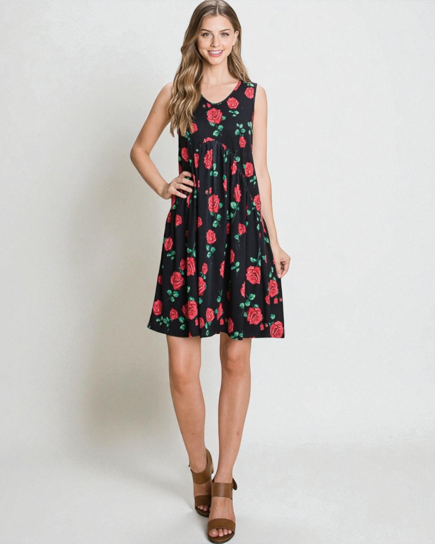 Woman wearing a black dress with red floral pattern on a white background